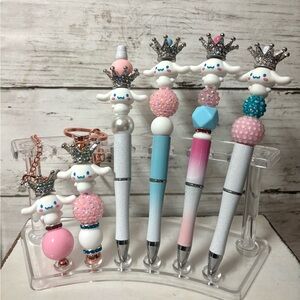 Sanrio cinnamon roll pens, keychains, and Stanley charms